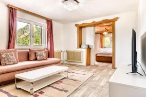 A television and/or entertainment centre at Familienferienwohnung Buerserberg Dorf by A-Appartments
