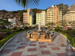 a fountain in the middle of a city with buildings at Huong Cang Sea View Hotel in Cat Ba