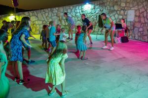 a group of people dancing on a dance floor at Apartments Jezera Lovišća in Jezera