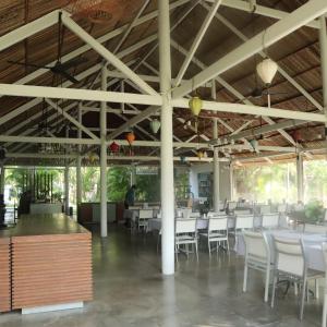 une salle à manger avec des tables et des chaises blanches dans l'établissement Villa Panda - Sanctuary Ho Tram Resort, à Ho Tram