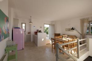 a kitchen and dining room with a pink refrigerator at Kallisti Rodia - Dream Villa with Views Garden nr Best kid's Beach in Santa Maria