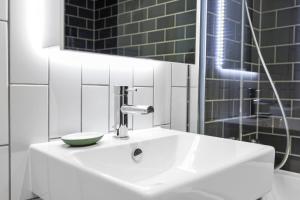 a bathroom with a sink with a bowl on it at Cave Apartments in London