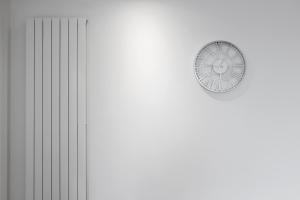 a clock on the side of a wall at Cave Apartments in London