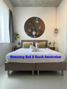 um quarto com uma cama e um quadro na parede em Bed & Beach Amsterdam em Amsterdã