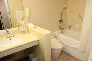 a bathroom with a sink and a toilet and a tub at ANA Crowne Plaza Hotel Kyoto by IHG in Kyoto