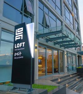 a building with a sign in front of it at Loft Hotel Apartment in Addis Ababa