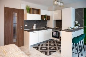 a kitchen with white cabinets and a stove top oven at Modern Central Studio in Sofia