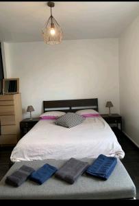 een slaapkamer met een bed met twee blauwe handdoeken erop bij Massi'z in Neuilly-sur-Marne