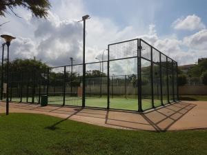 a batting cage on a tennis court in a park at Nature II in El Verger