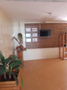a living room with a flat screen tv on a wall at Espaço do Bem Recife in Recife
