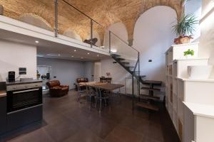 a kitchen and dining room with a staircase and a table at L'ira di Dante in Gubbio