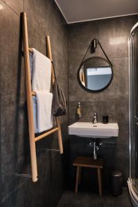 a bathroom with a towel rack and a sink at Vanadziņa māja in Cēsis
