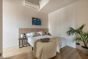 1 dormitorio con 1 cama y una maceta en Líbere Madrid Palacio Real en Madrid