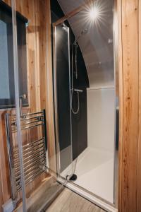 a shower with a glass door in a bathroom at North Coast 500 Pods in Achmelvich