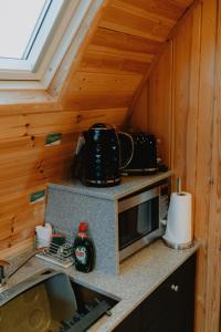a kitchen with a microwave and a counter top at North Coast 500 Pods - Brora in Brora