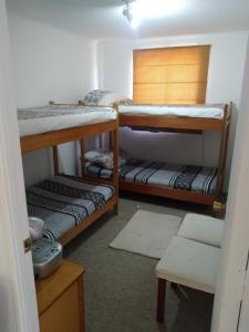 a room with three bunk beds in a room at Dpto Cau Cau Horcón in Puchuncaví