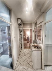 a hallway with a refrigerator and a living room at UNDER the SKY in Rijeka