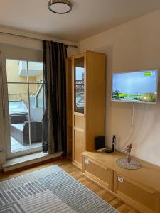 a bedroom with a flat screen tv on the wall at Appartement 4You in Schladming