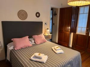 a bedroom with a bed with two towels on it at La Yurta in Mar del Plata