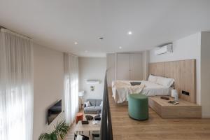 a bedroom with a bed and a table in a room at Líbere Madrid Palacio Real in Madrid