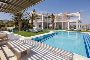 a villa with a swimming pool and a house at Gerani Hill in Gerani