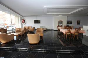 a dining room with tables and chairs and a television at Kommageneiz hotel in Adıyaman