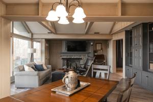 a living room with a table and a fireplace at Inn at Crestwood in Boone