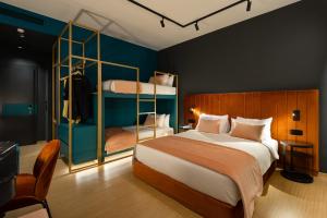 a bedroom with a bed and a bunk bed at COLORS Hotel Athens in Athens