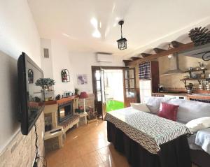a living room with a couch and a tv at tuGuest Carataunas Apartment Alpujarra V in Carataunas