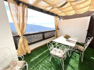a balcony with a table and chairs and a view at tuGuest Carataunas Apartment Alpujarra V in Carataunas