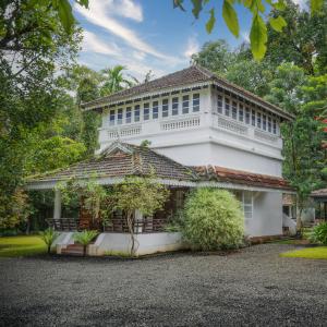 a white house with a roof at MAI HOUSE HERITAGE HOTEL in Fort Kochi