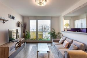 Televízia a/alebo spoločenská miestnosť v ubytovaní Le Lounge - 2 chambres avec parking