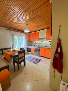 a kitchen with orange cabinets and a table in it at Cozy Flat with Backyard and Fireplace in Sapanca in Sapanca