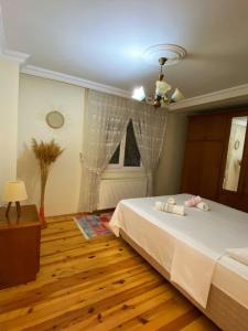 a bedroom with a white bed and a window at Cozy Flat with Backyard and Fireplace in Sapanca in Sapanca