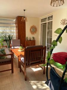 a living room with a table and a chair and a plant at Cozy Flat with Backyard and Fireplace in Sapanca in Sapanca