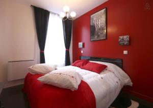 - une chambre rouge avec un lit aux murs rouges et une fenêtre dans l'établissement Mairie de Saint-Ouen (Métro 13/14), à Saint-Ouen