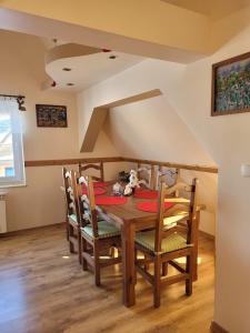 a dining room with a wooden table and chairs at Apartament Złap Oddech in Zakopane