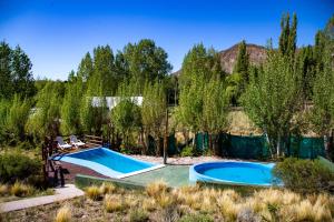 an image of two swimming pools in a yard at Cabañas Mirador Azul, Potrerillos in Potrerillos