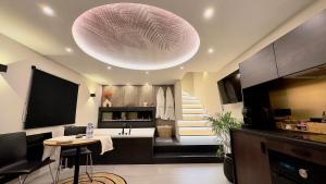 a kitchen with a large pink orb hanging from the ceiling at Maison Nina, Suite d’exception in LʼÎle-Saint-Denis +35 photos