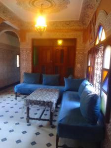 a living room with blue couches and a table at Riad Dar Zaida in Marrakech