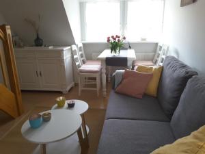 a living room with a couch and a table at Seepferdchen in Nebel