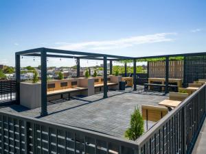 a rooftop patio with tables and benches on a building at Brooklyn Bay Unique Stay Private LUXURY LOFT in Brooklyn