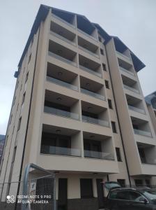 a building with a parking lot in front of it at Sjaj bregova in Zlatibor +6 photos