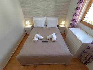 a small bedroom with a bed with towels on it at Room Dream Beato in Lisbon