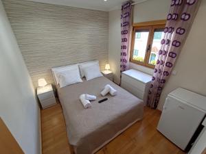 a small bedroom with a bed with towels on it at Room Dream Beato in Lisbon