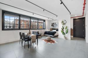 a living room with a table and chairs and a couch at Brooklyn Bay Full spacious Unique trendy loft in Brooklyn