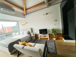 a living room with a couch and a tv at NiP Apartment | Porto City Center Near All Sights in Porto