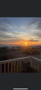 a sunset from the balcony of a house at Crimdon dene holiday park clifftop park in Hartlepool
