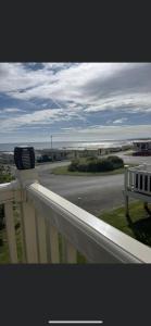 a white railing with a hair dryer on top of a balcony at Crimdon dene holiday park clifftop park in Hartlepool