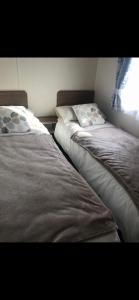 two beds sitting next to each other in a room at Crimdon dene holiday park clifftop park in Hartlepool